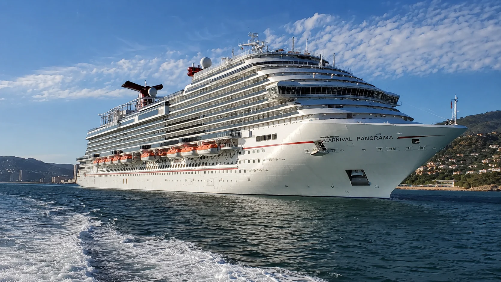 Carnival Panorama sailing near a mountainous coastline