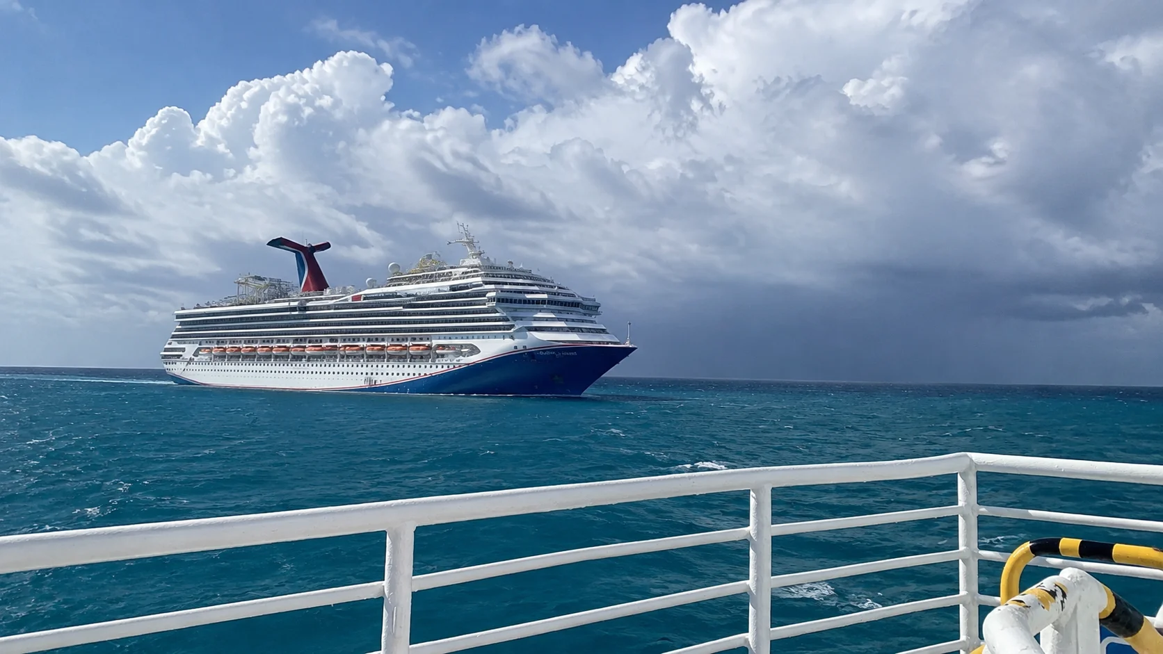 Carnival Sunshine sailing under cloudy skies