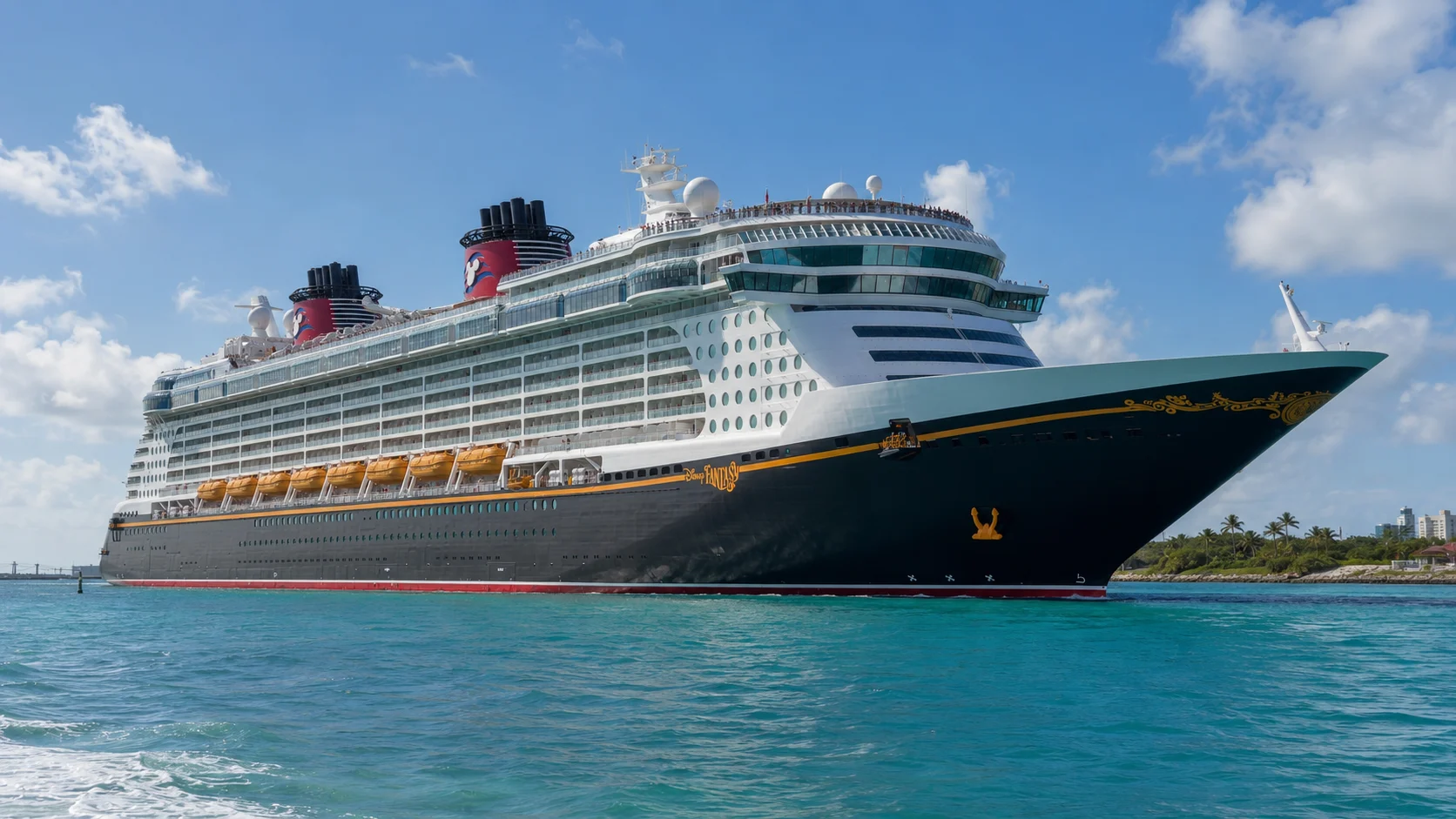 Disney cruise ship sailing through clear blue water