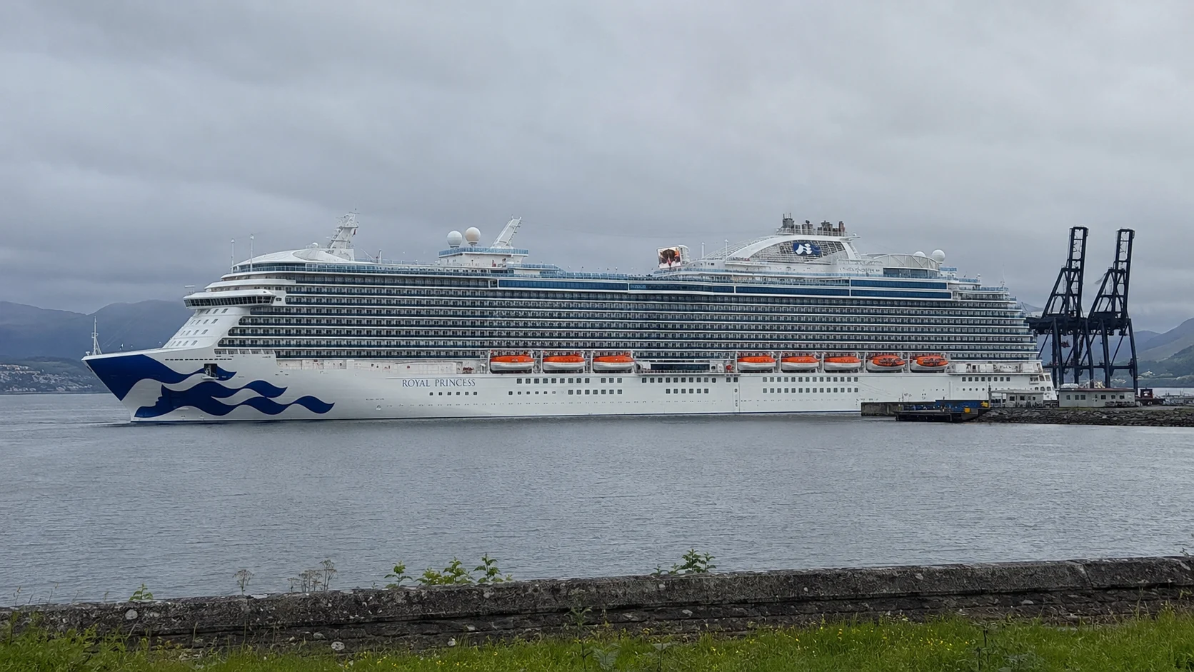 Princess cruise ship docked beneath an overcast sky