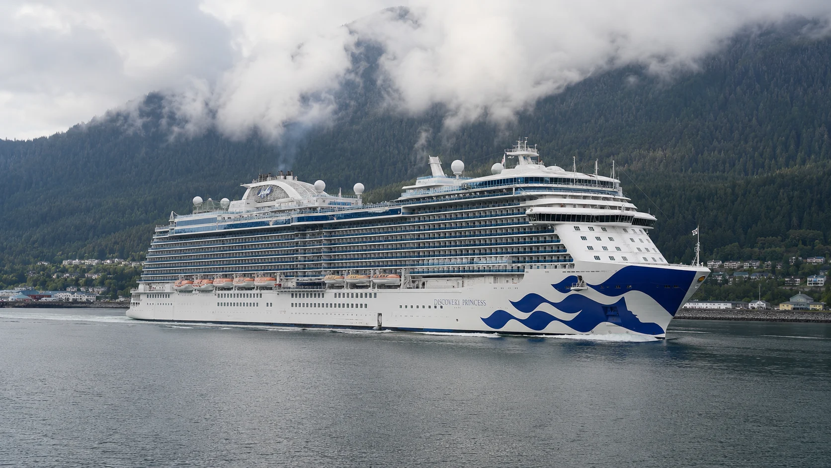 Princess cruise ship docked beside a misty forested fjord