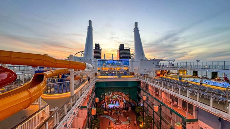 Cruise ship's open upper decks and waterslides at sunset