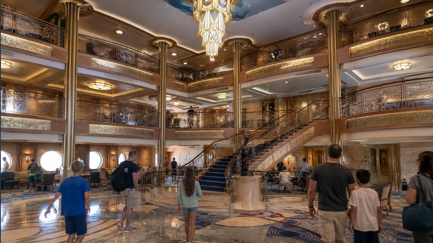 Disney Dream atrium with curved staircases and a crystal chandelier
