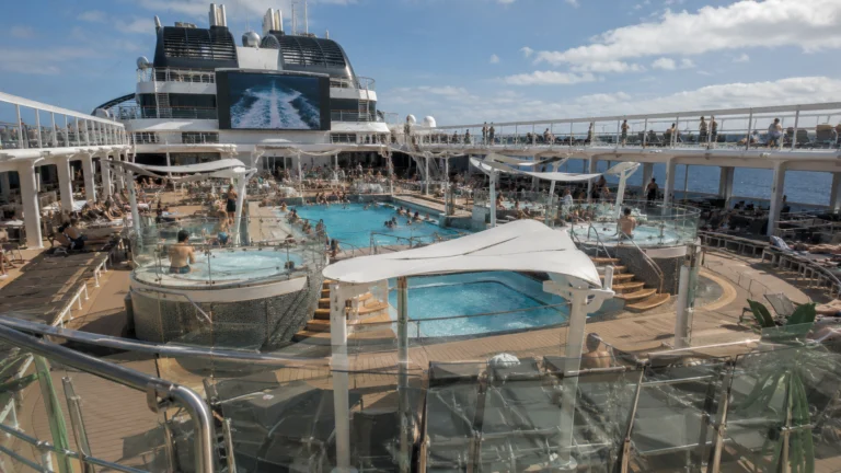 Busy cruise ship pool deck with a central swimming pool