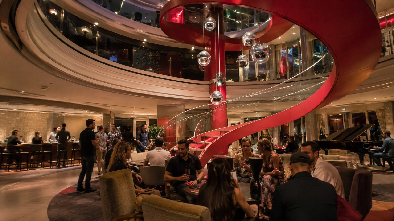 Red spiral staircase in the Roundabout atrium aboard Resilient Lady
