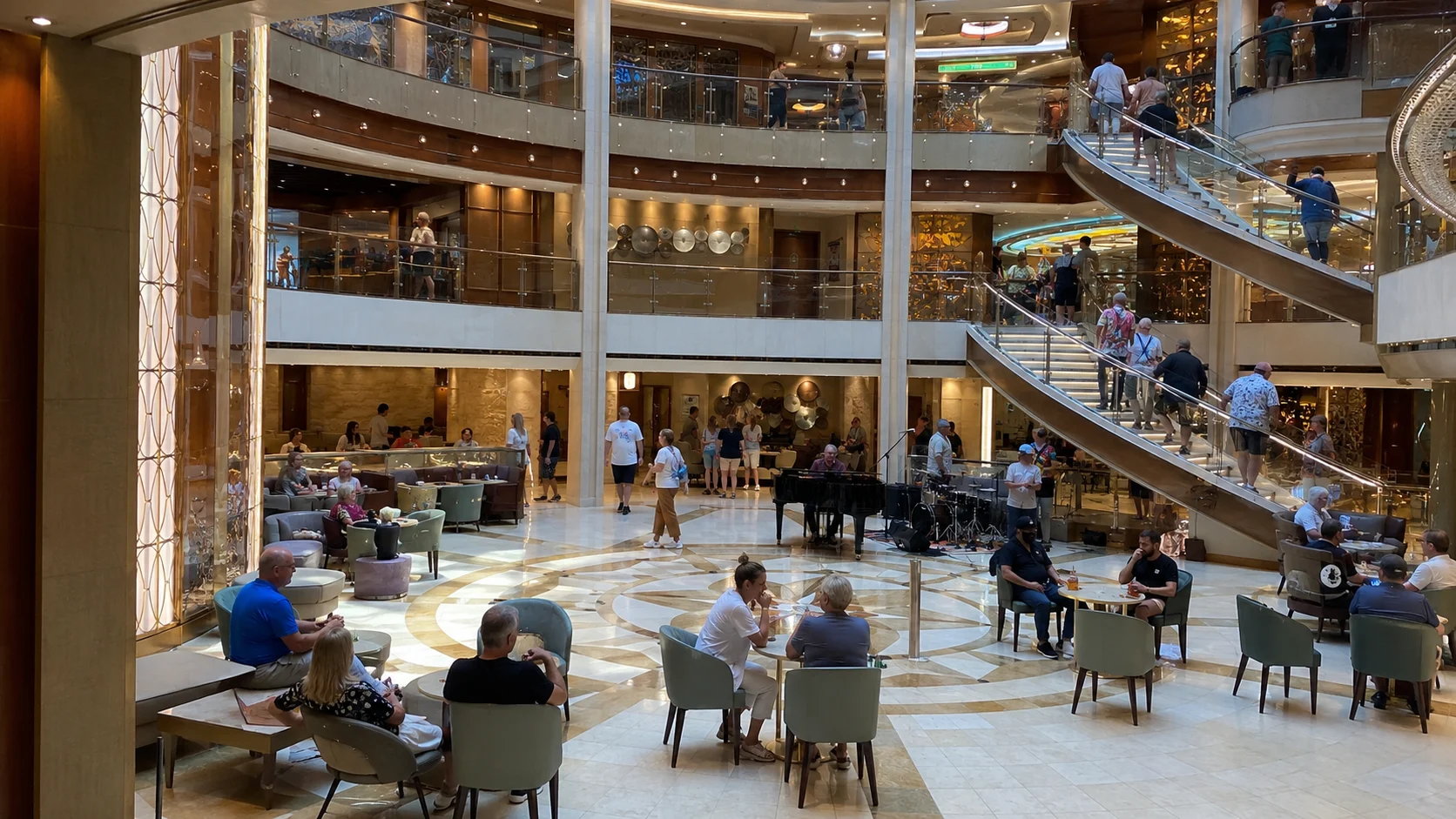 Cruise ship atrium with staircases, balconies and cafe seating