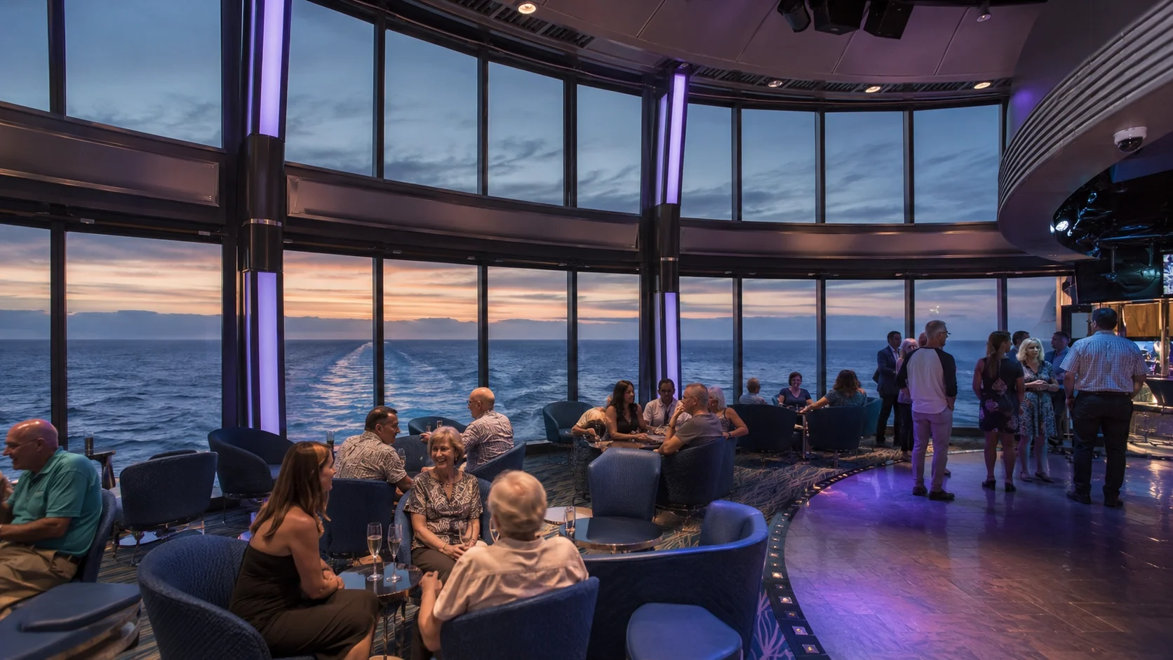 Guests in Skywalkers lounge overlooking the ocean at sunset