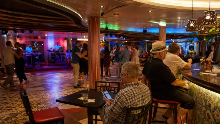 Guests seated at the Havana Bar on Carnival Panorama