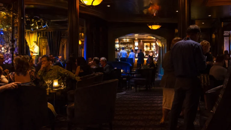 Guests relaxing in a dimly lit cruise ship nightclub