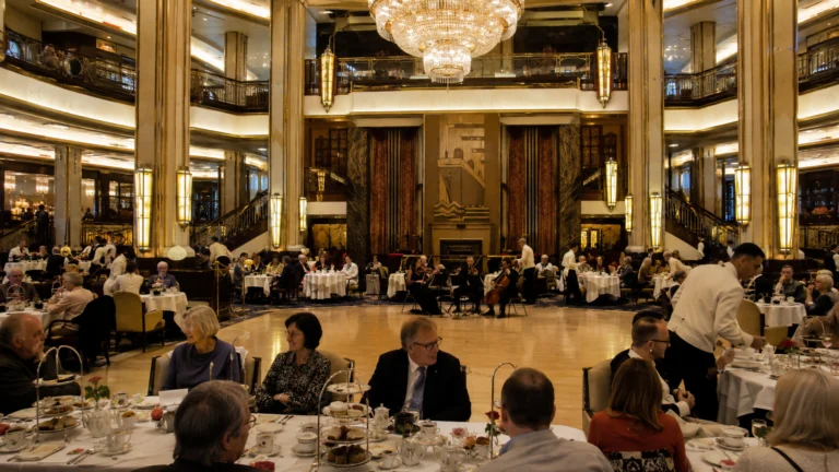 Passengers dining in an elegant two-level ballroom