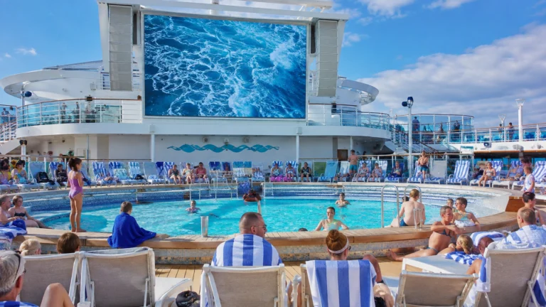 Guests relaxing around the Calypso Pool on Caribbean Princess