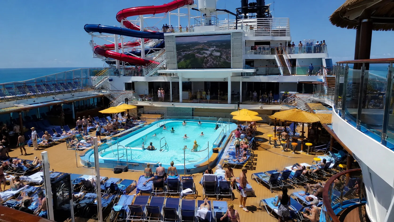 Guests relaxing around the Beach Pool on Carnival Horizon