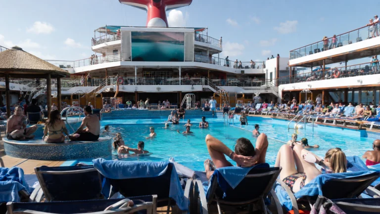 Guests relaxing around the Beach Pool on Carnival Sunshine