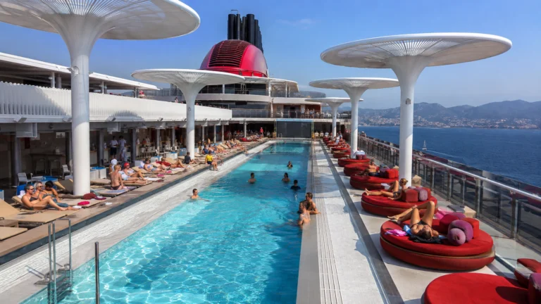 Pool deck with red loungers aboard Valiant Lady
