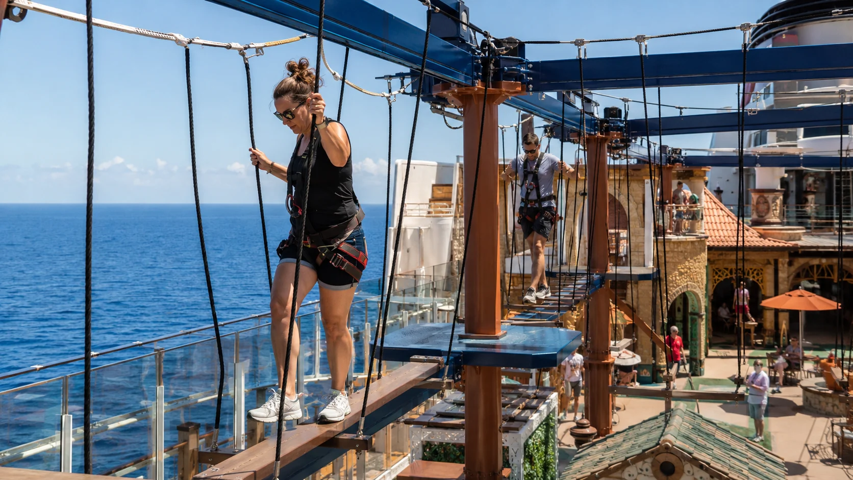 Woman crossing the ropes course above Carnival Firenze's deck