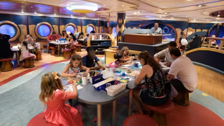Children and parents doing crafts in a colorful cruise ship activity room