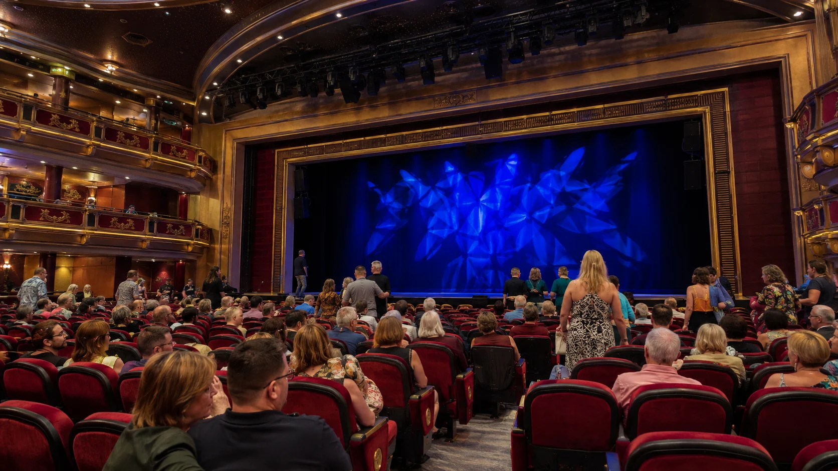 Guests seated and standing in Carnival Firenze's main theater