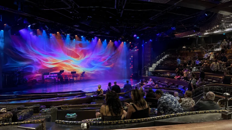 Audience watching a colorful show in Carnival Panorama's Liquid Lounge