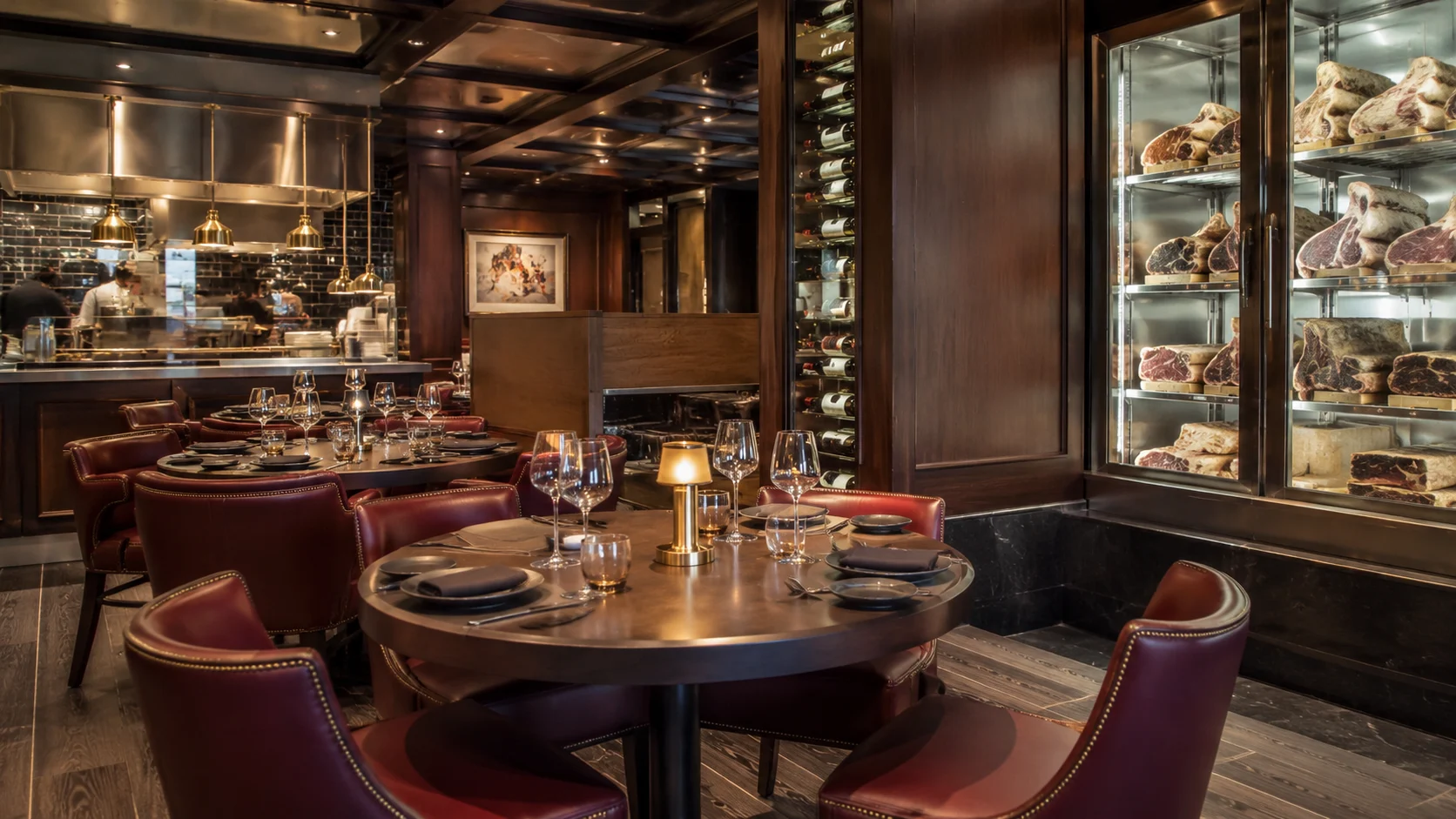 Elegant steakhouse with red leather chairs and a glass meat display