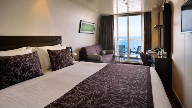 Balcony cabin with a purple patterned bed runner and matching sofa