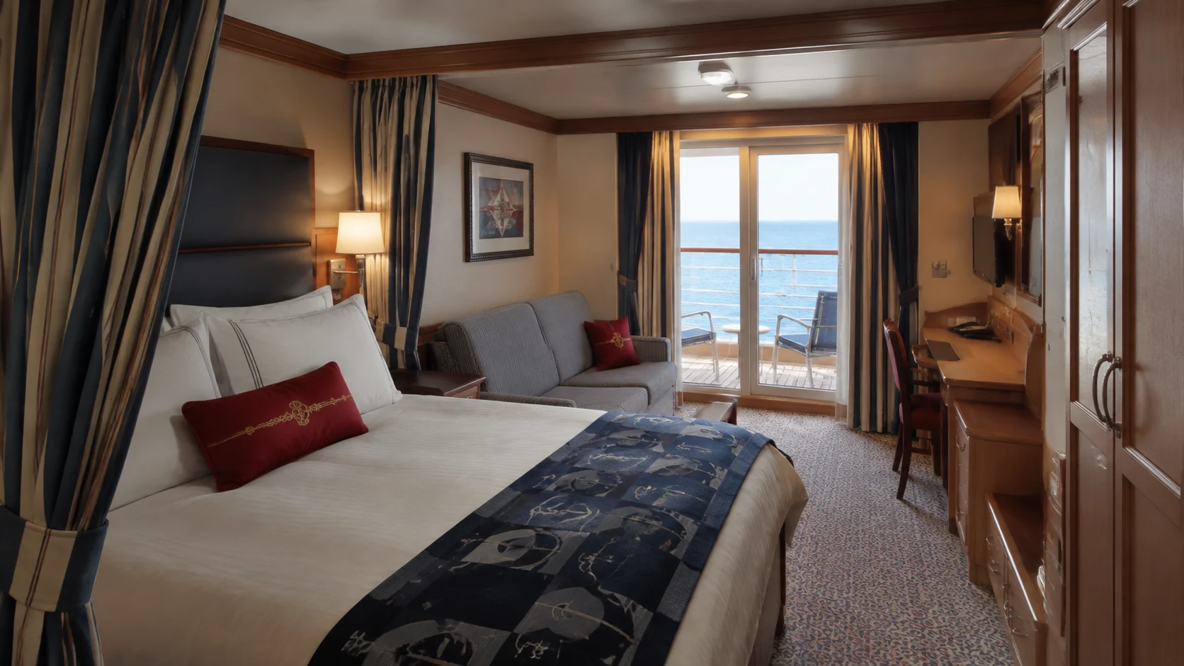 Disney-style balcony cruise cabin with a double bed and red accent pillow
