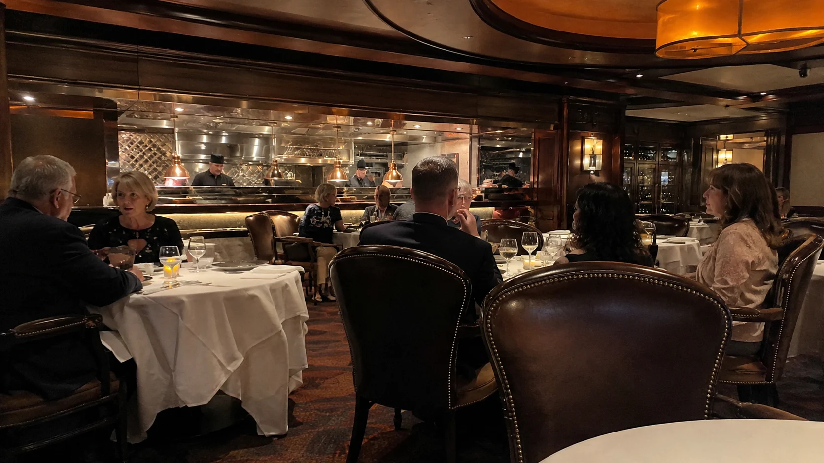 Guests dining in a dark wood-paneled specialty restaurant