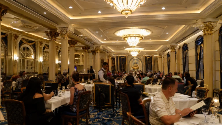 Guests dining beneath chandeliers in an elegant formal restaurant
