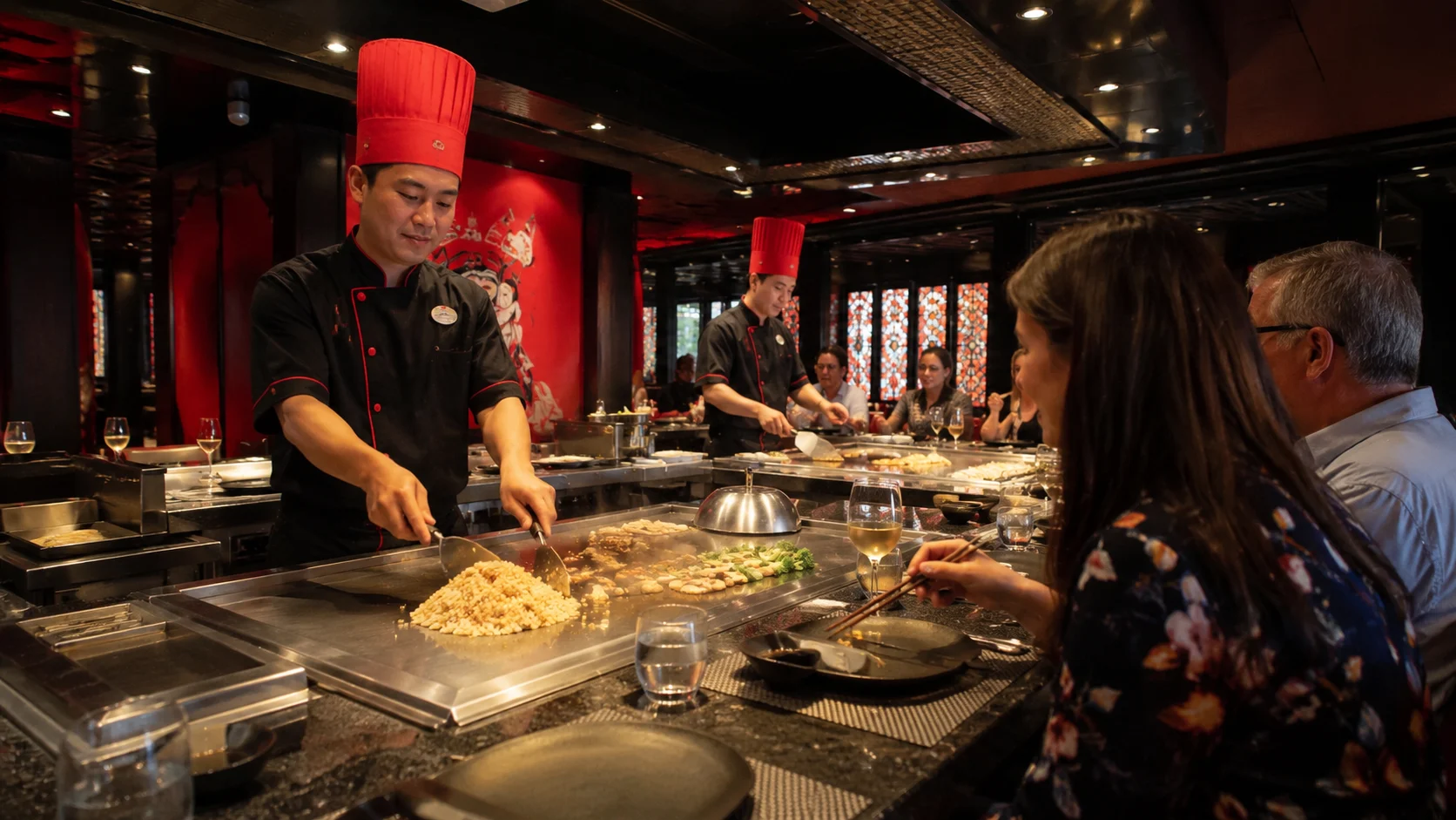 Chef cooking on a teppanyaki grill for cruise passengers