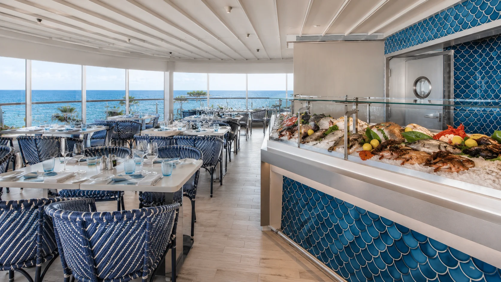 Bright ocean-view restaurant with a chilled seafood counter