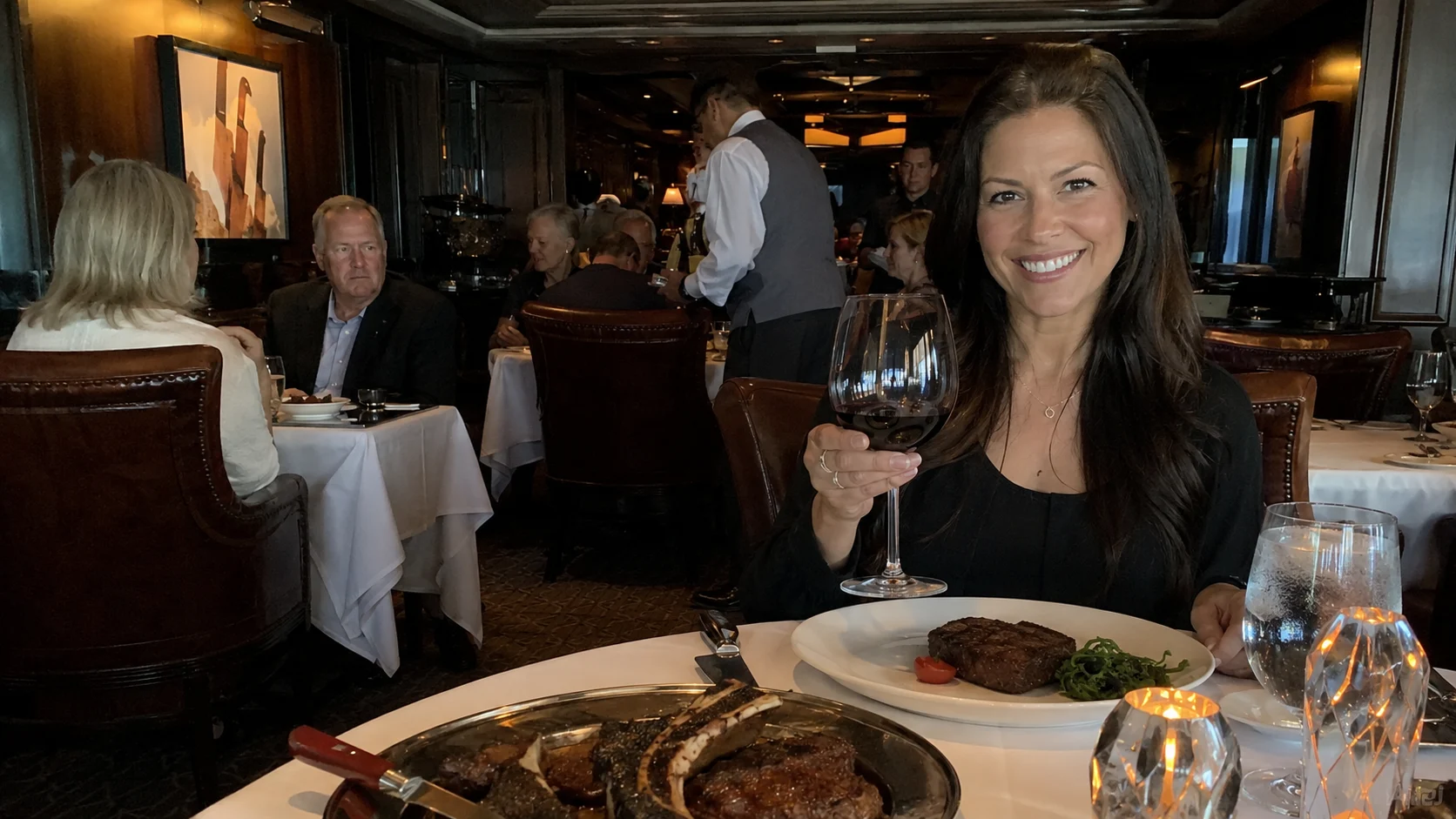 Woman dining on steak in an elegant cruise ship restaurant