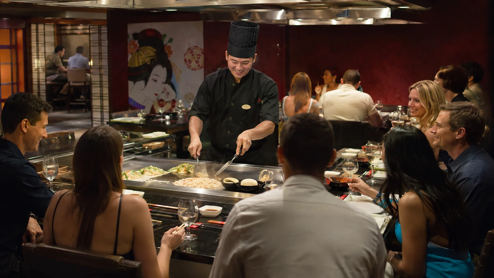 Teppanyaki chef cooking for guests aboard Norwegian Epic