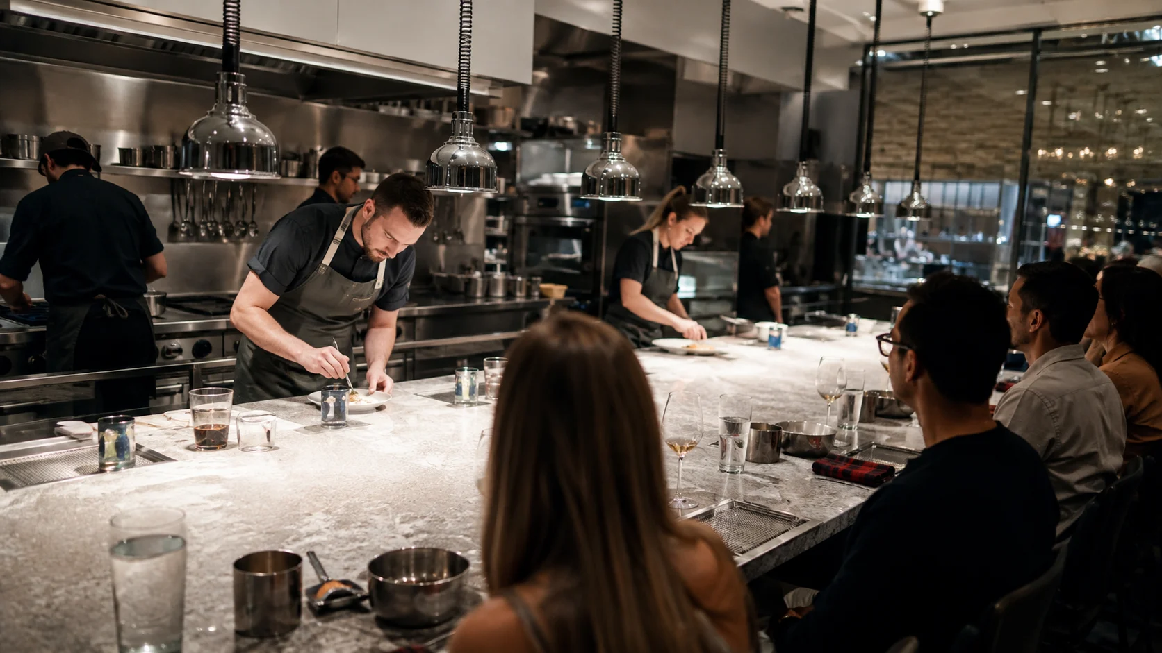Chefs preparing dishes for diners at The Test Kitchen on Resilient Lady