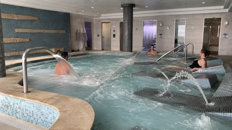 Tiled spa pool with wall jets and passengers relaxing in the water