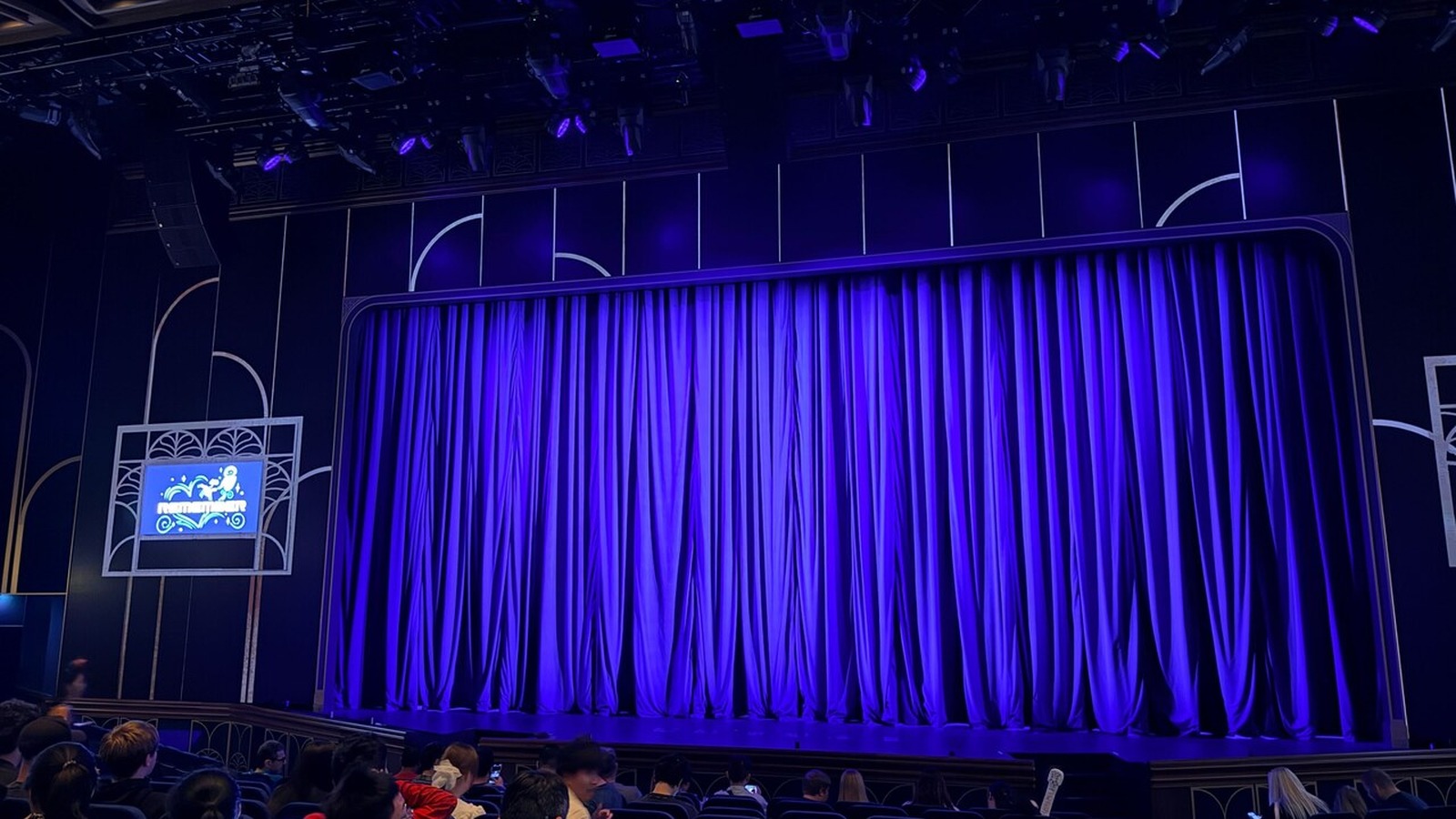 Blue stage curtain inside a cruise ship theater