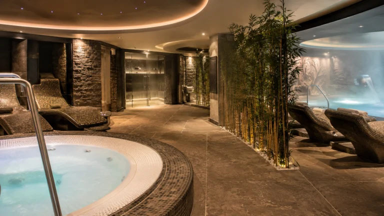 Serene cruise ship spa with a round whirlpool and stone loungers