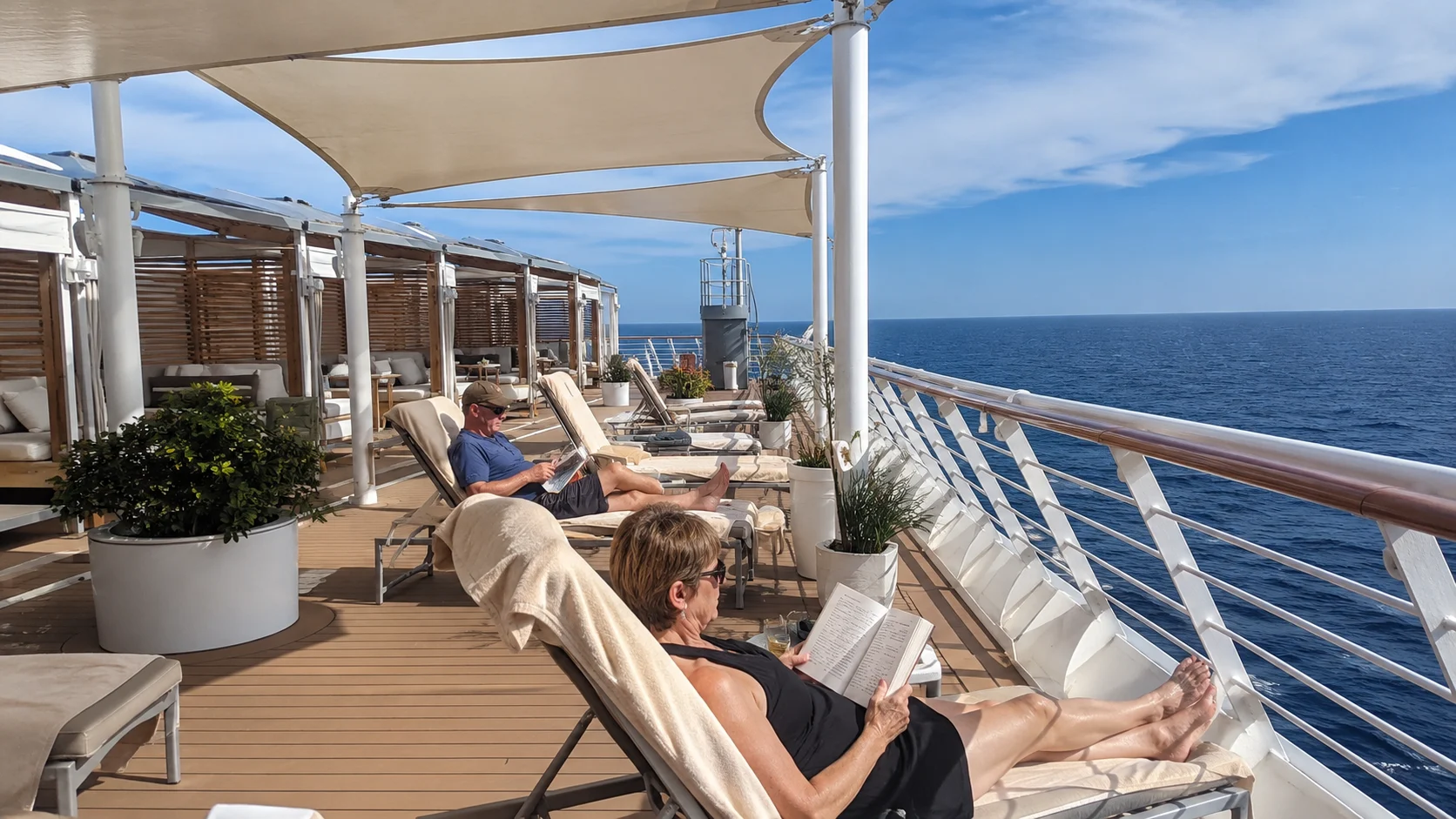 Passenger reading on a quiet adults-only sun deck