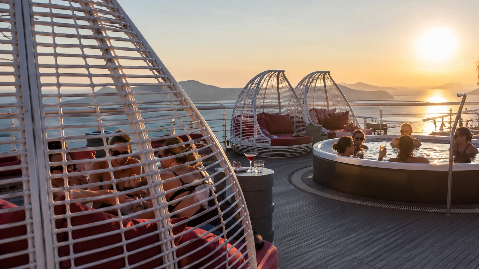Guests relaxing at Richard's Rooftop aboard Valiant Lady at sunset