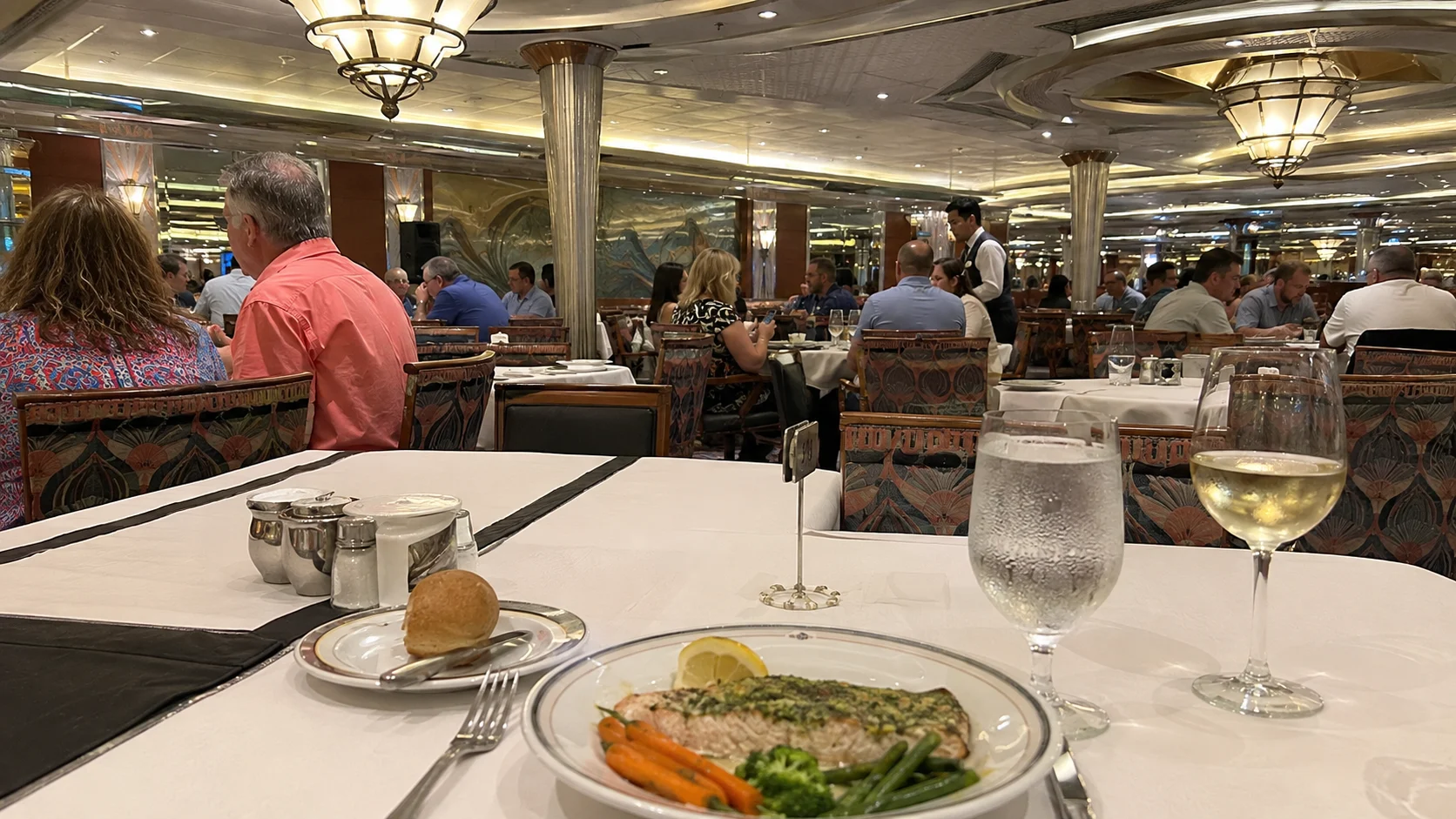 Fish and vegetables served in a busy cruise ship dining room