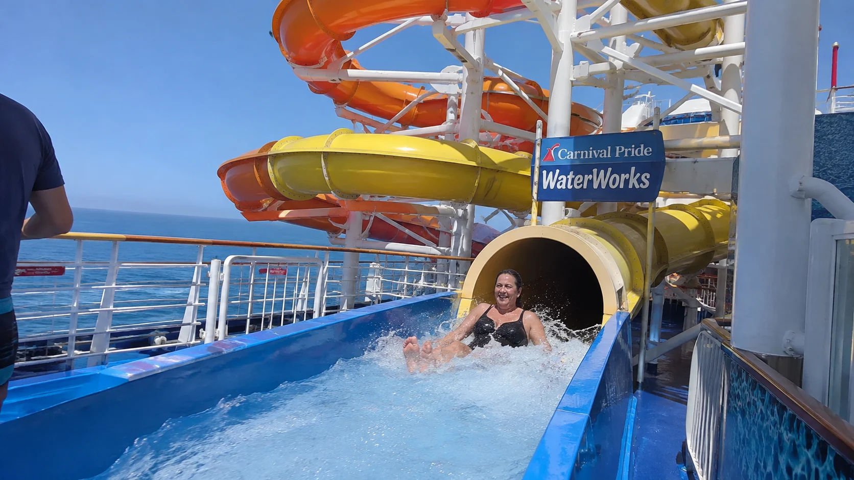 Passenger emerging from a waterslide at Carnival Pride WaterWorks