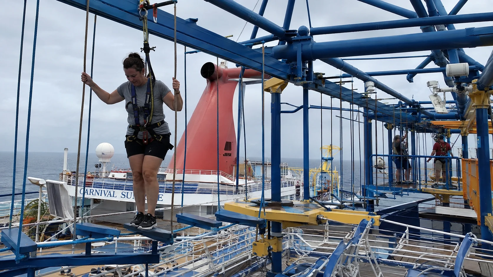 Passenger wearing a safety harness on the ropes course aboard Carnival Sunrise