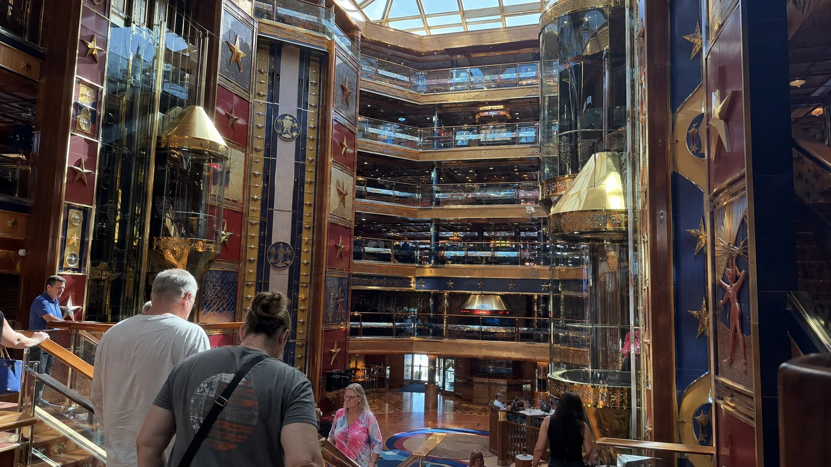 Passengers overlooking Carnival Valor's tall multilevel atrium