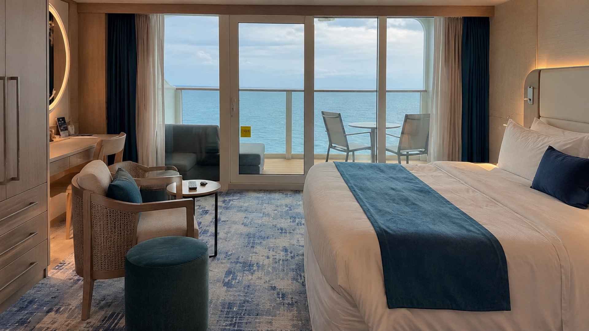 A balcony stateroom with an ocean view and a seating area