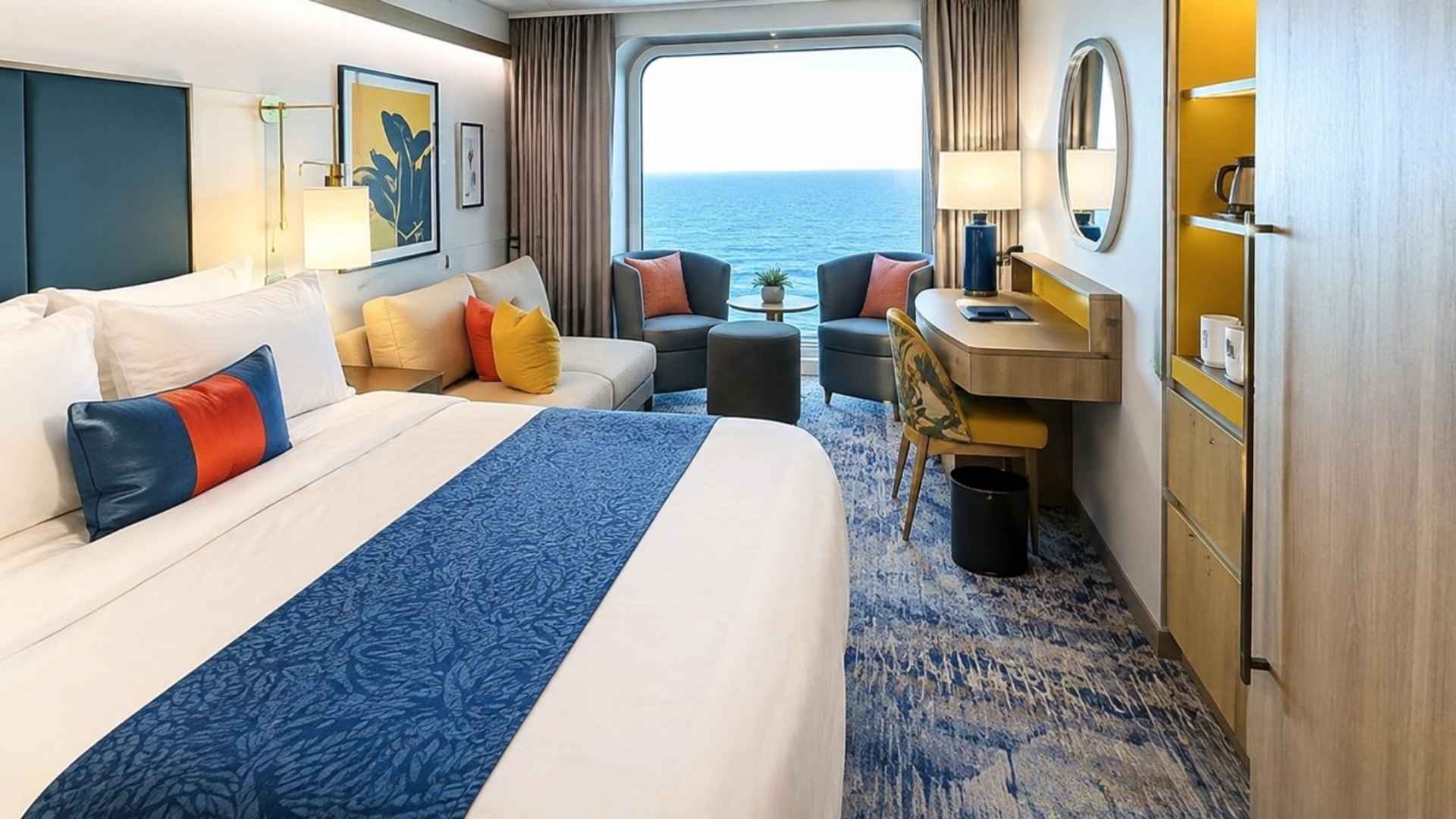 Balcony stateroom on Icon of the Seas with a vanity desk, round mirror and glass doors to the sea