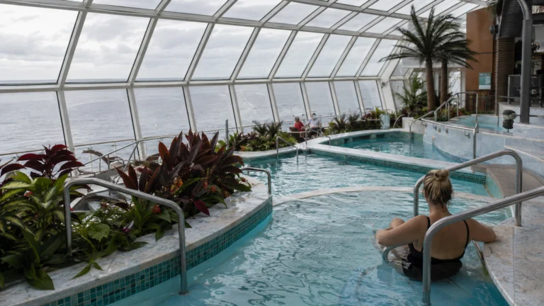 Guest relaxing in Quantum of the Seas Solarium pool