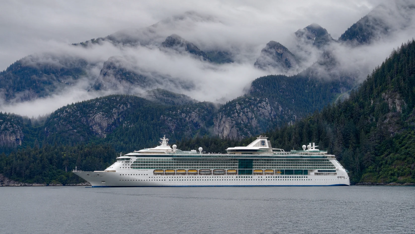 Radiance of the Seas sailing through misty Alaskan mountains