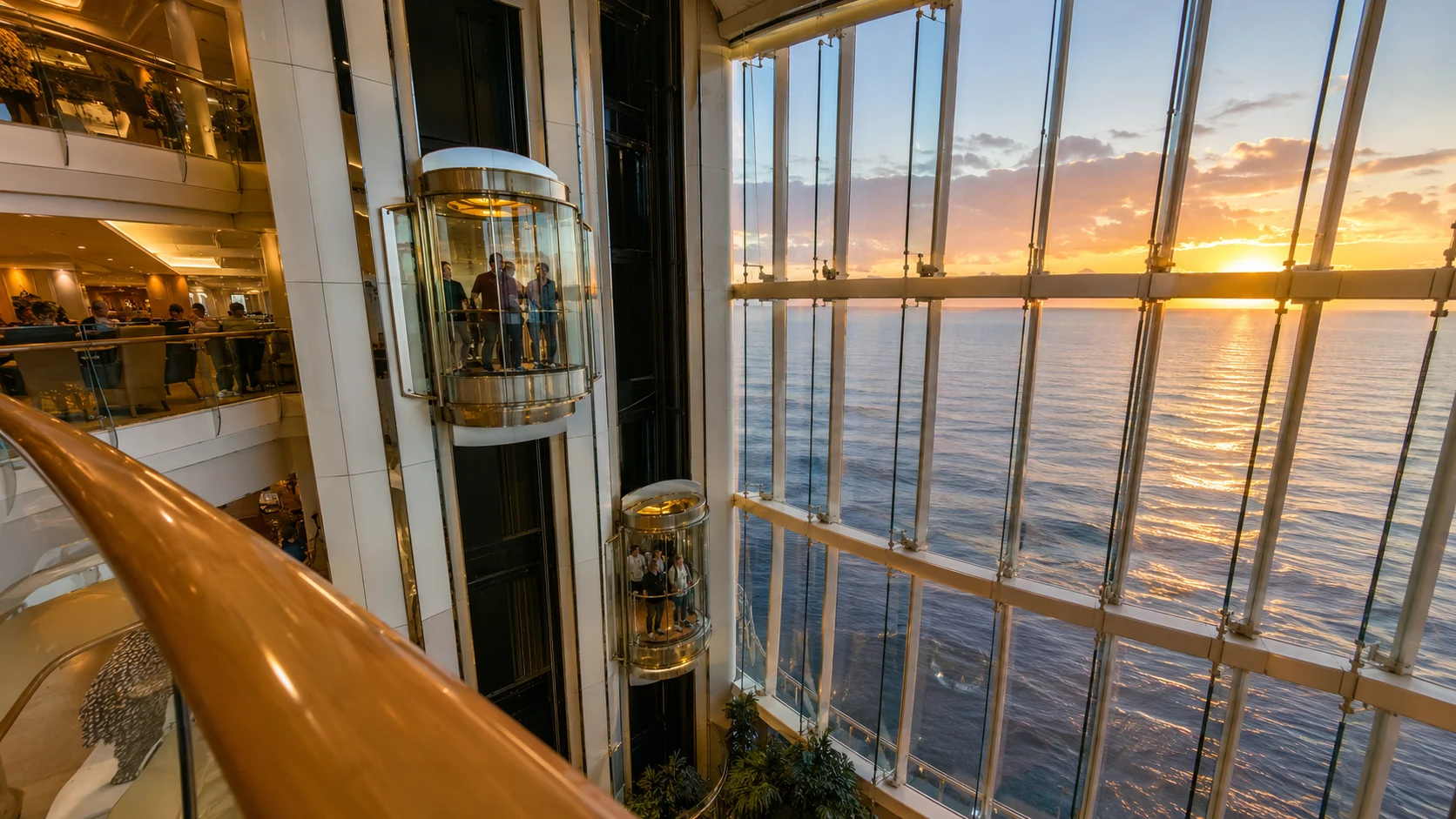 Glass elevators overlooking the ocean at sunset aboard Radiance of the Seas