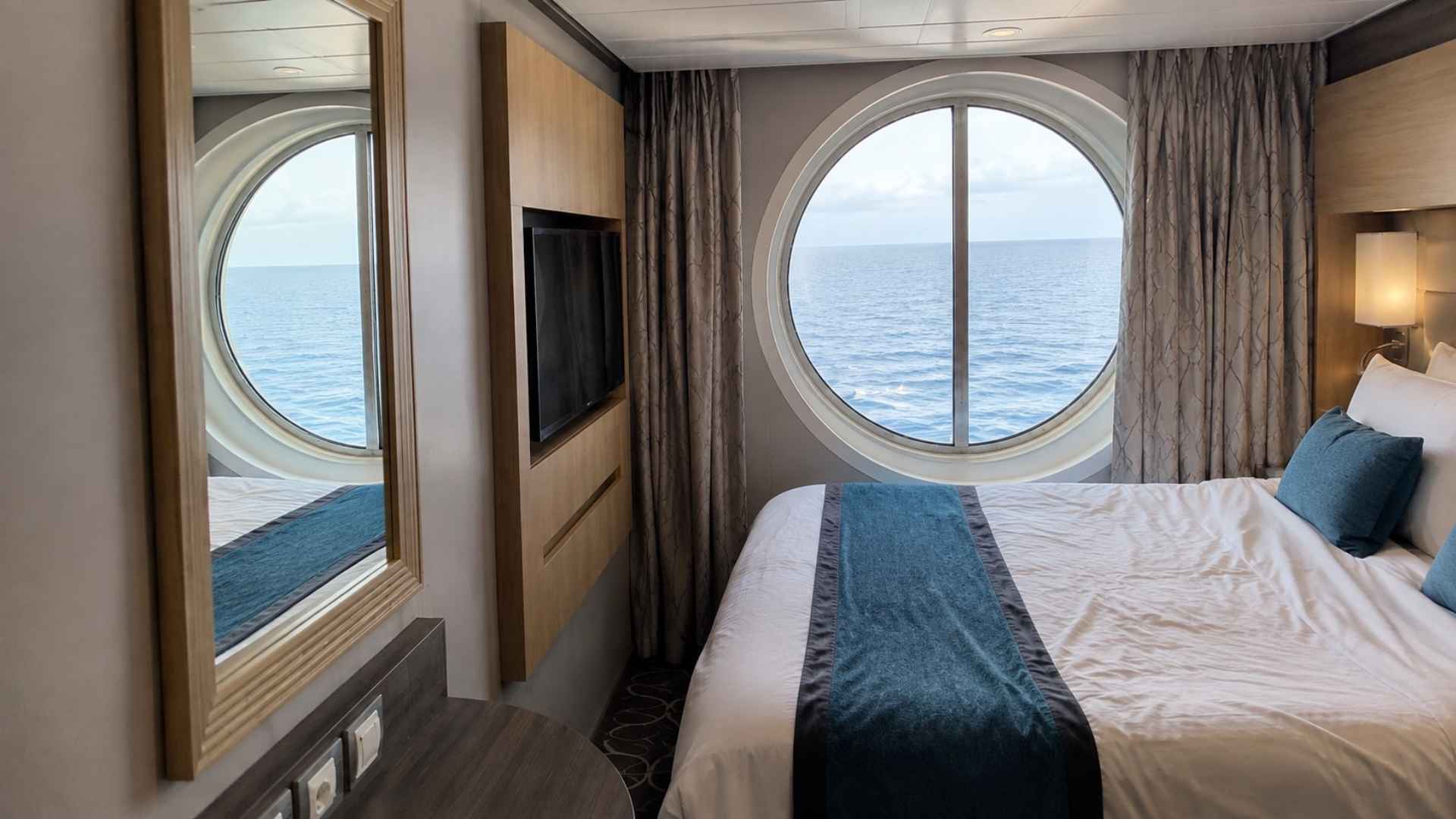 Oceanview cabin on Symphony of the Seas with a large round window looking out to sea