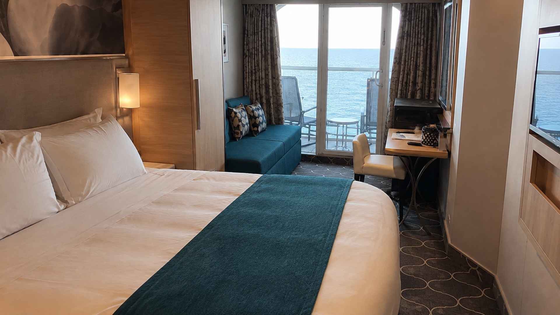 Balcony cabin on Symphony of the Seas with a chair on the balcony and an ocean view