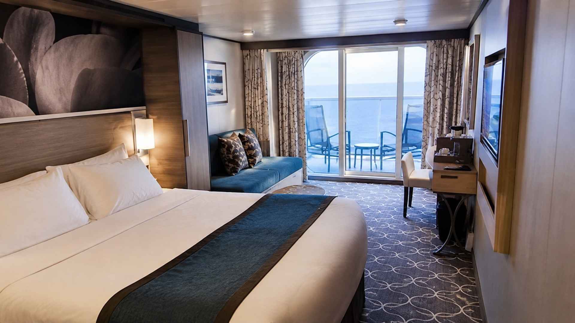 Balcony cabin on Wonder of the Seas with two chairs on the balcony and an ocean view
