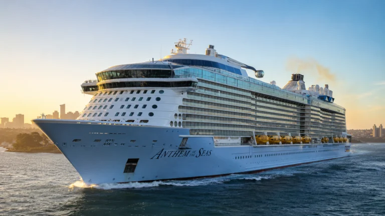 Anthem of the Seas sailing near a city skyline